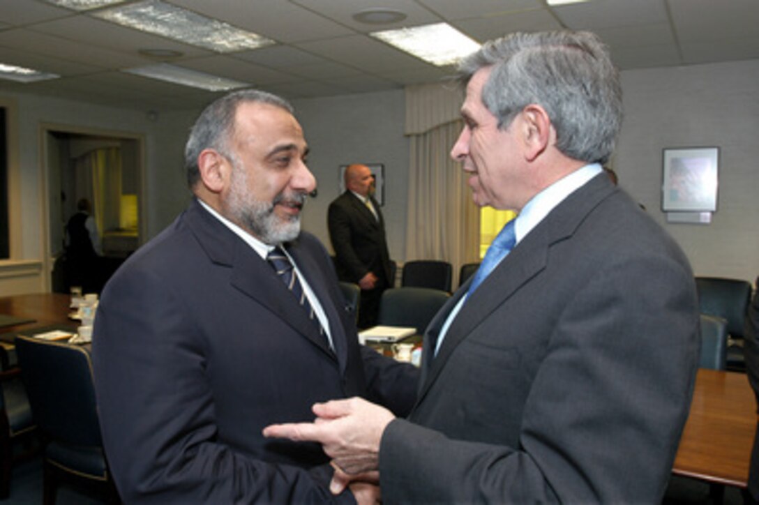 Deputy Secretary of Defense Paul Wolfowitz (right) welcomes Iraqi Vice President Adil Abdul Mahki (left) to the Pentagon for security talks on April 22, 2005. 