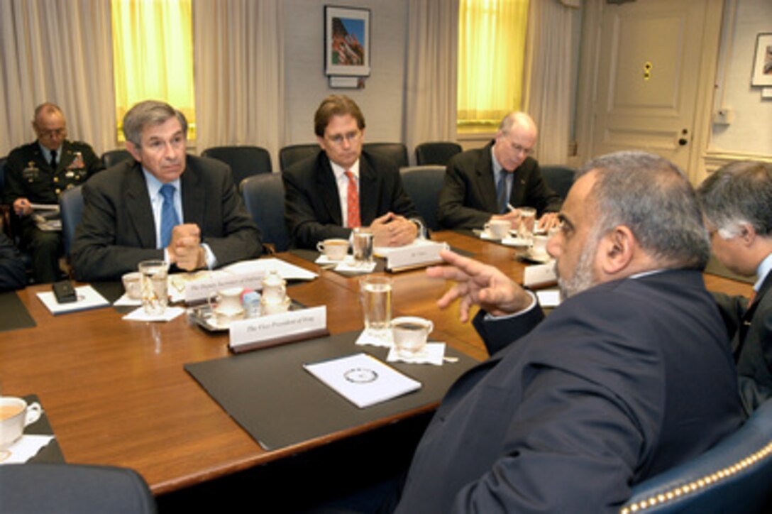 Deputy Secretary of Defense Paul Wolfowitz (left) hosts a Pentagon meeting with Iraqi Vice President Adil Abdul Mahki (foreground) on April 22, 2005. Joining Wolfowitz on the U.S. side of the table are Principal Deputy Assistant Secretary of Defense for International Security Affairs Peter Flory (center) and DoD Country Director for Iraq Chris Staub (right). 