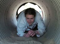 A candidate crawls through a corrugated aluminum tunnel at Fort McCoy, Wis., April 23.