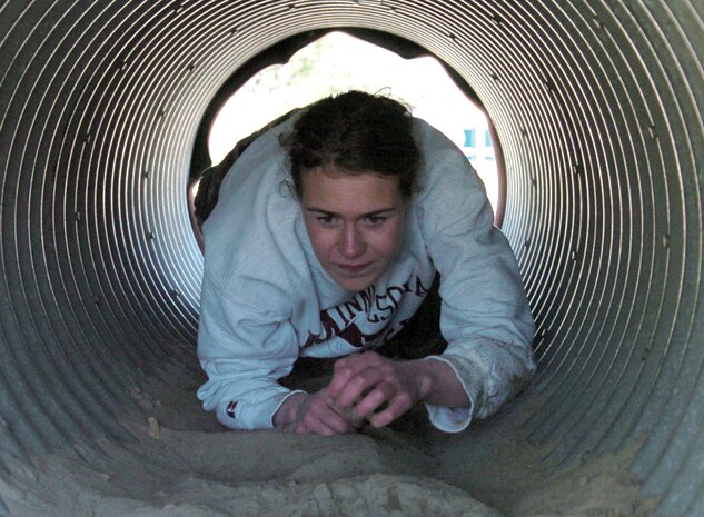 A candidate crawls through a corrugated aluminum tunnel at Fort McCoy, Wis., April 23.