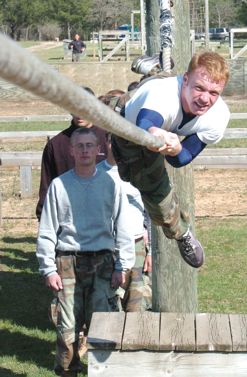 A candidate hangs from a rope suspended 15 feet from the ground at Fort McCoy, Wis., April 23.