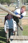 A candidate hangs from a rope suspended 15 feet from the ground at Fort McCoy, Wis., April 23.