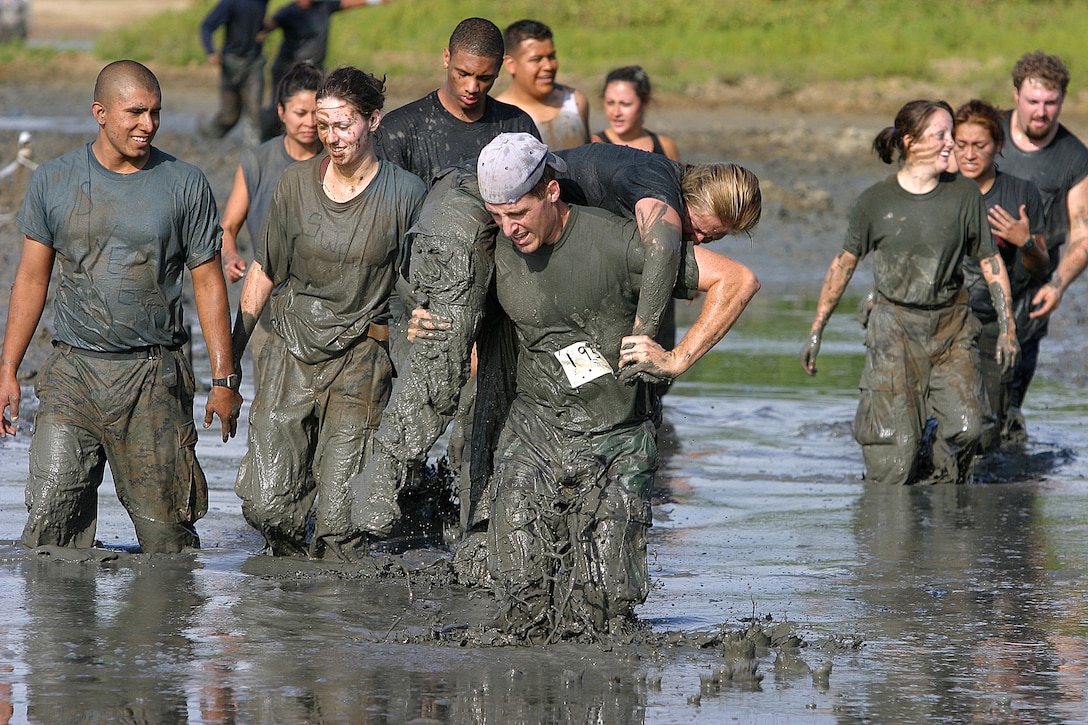 Timm Heisey carries Drunken Monkeys teammate Sarah Nicholas through the thick mud of the Nuupia Ponds. All of the women on the team were from Hickam Air Force Base Dental clinic.