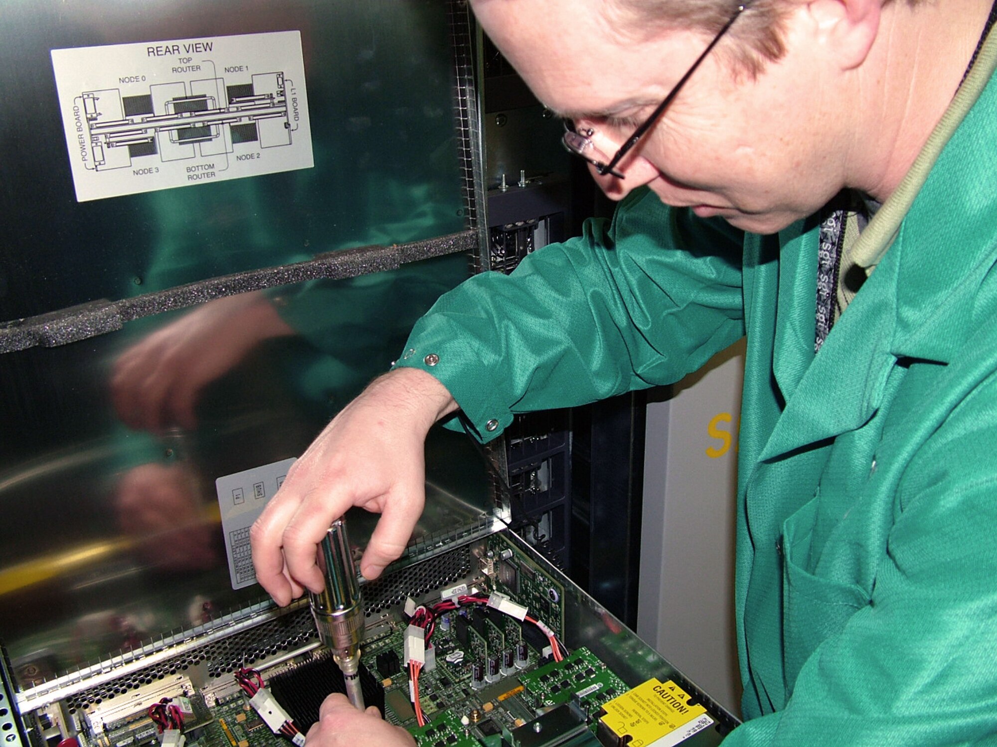 WRIGHT-PATTERSON AIR FORCE BASE, Ohio -- Kevin Maloney installs the newest high performance computer system in Aeronautical Systems Center's major shared resource center here.  The new system expands the resource center's supercomputing capability to more than 4,100 processors spread across five separate shared memory systems.  Mr. Maloney is with a contractor providing onsite support.  (U.S. Air Force photo by 1st Lt. David Cromwell)