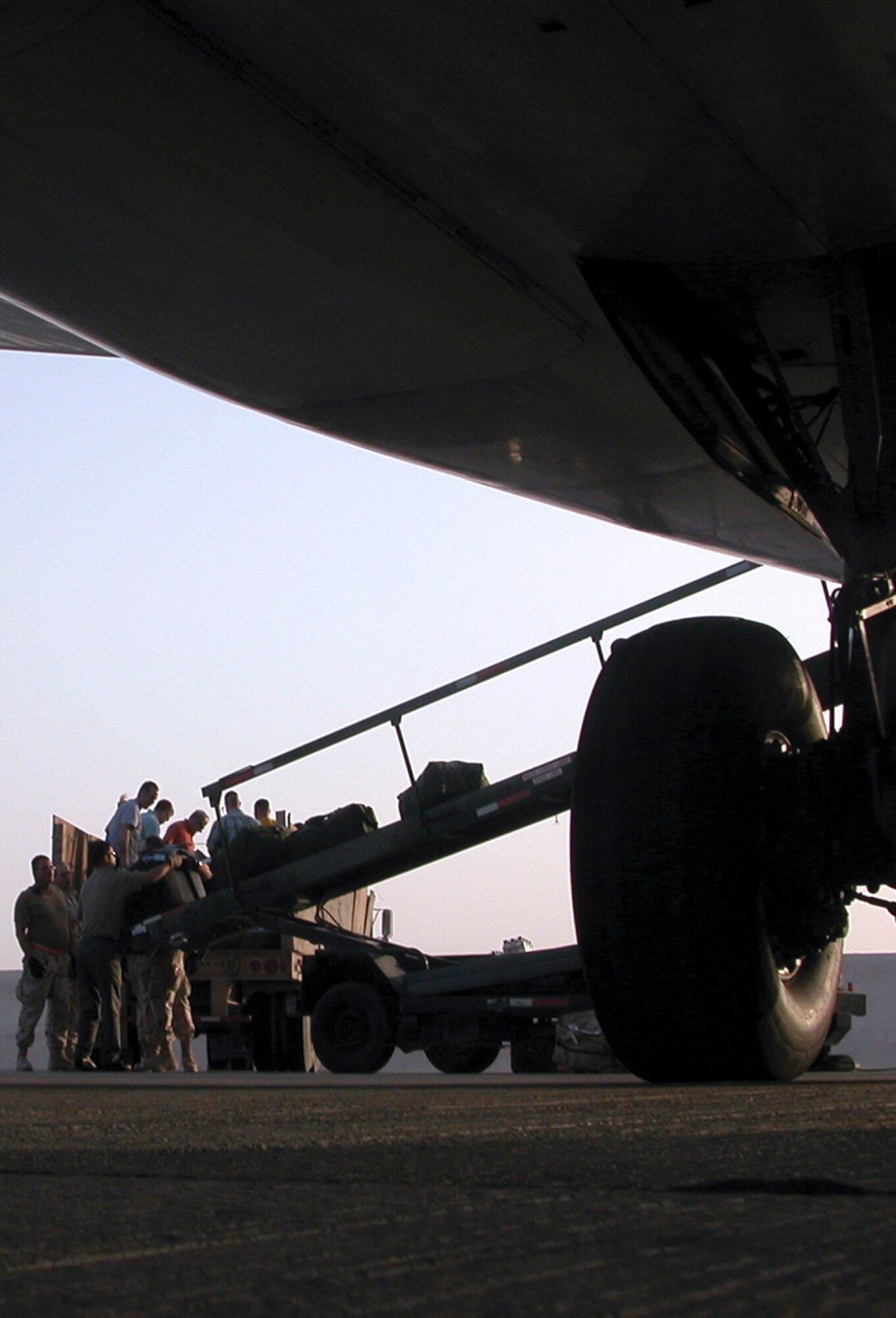 SOUTHWEST ASIA -- Passengers and 8th Expeditionary Air Mobility Squadron Airmen unload luggage from a rotator flight at a forward-deployed location.  Airmen from the 8th EAMS, along with the 379th Expeditionary Logistics Readiness Squadron's reception control center and the 379th Expeditionary Mission Support Group's personnel support for contingency operations office, are responsible for processing servicemembers in and out of U.S. Central Command's area of responsibility.  (U.S. Air Force photo by Senior Airman Karah Manning)