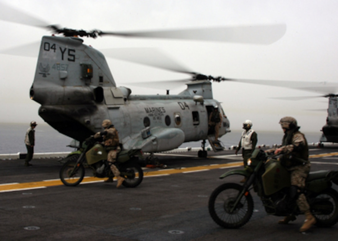 Marines from the 26th Marine Expeditionary Unit prepare to load their KLR 250-D8 motorcycles into a CH-46E Sea Knight helicopter on the flight deck of the amphibious assault ship USS Kearsarge (LHD 3) during flight operations in the Mediterranean Sea on April 18, 2005. The motorcycles allow the Marines an alternative means of transporting messages, documents, or light cargo and conducting reconnaissance in the field. Kearsarge and the embarked 26th MEU are on a regularly scheduled deployment in support of the war on terror. 