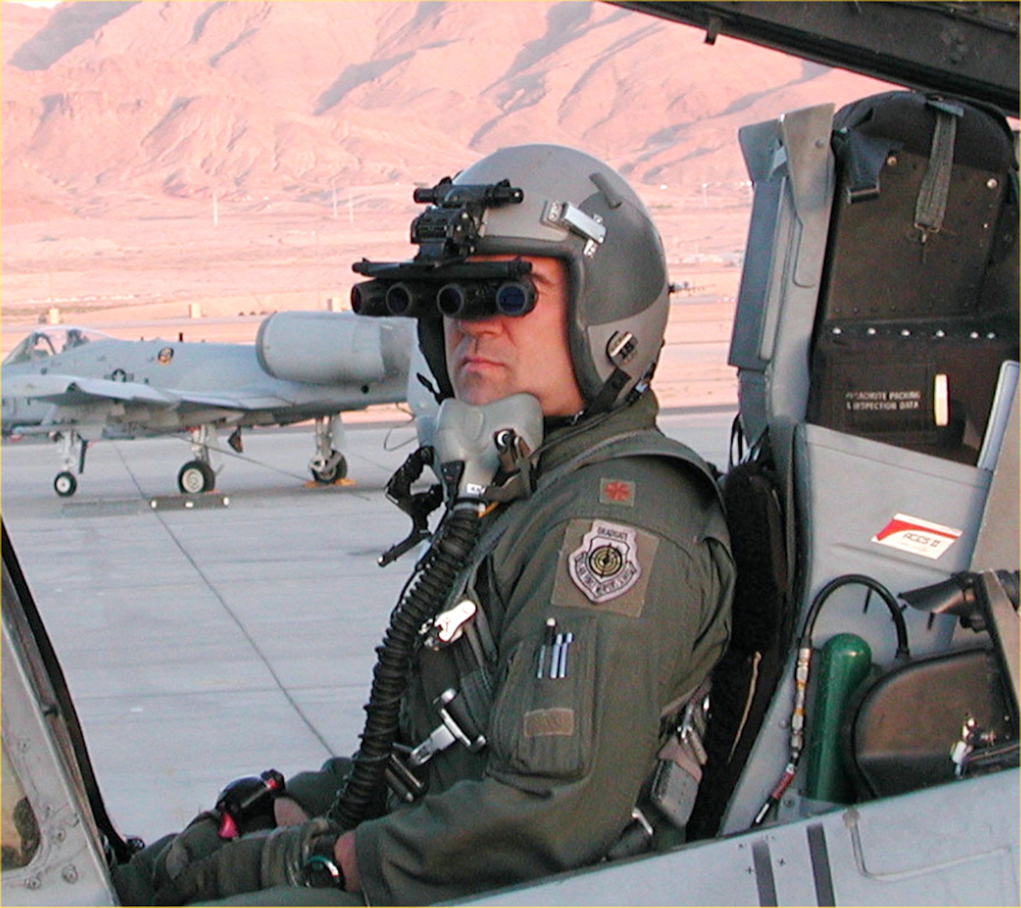 NELLIS AIR FORCE BASE, Nev. -- A pilot with the 422nd Test and Evaluation Squadron here tests panoramic night-vision goggles on an A-10 Thunderbolt II.  The first shipment of PNVGs was received April 25 by special operations Airmen for use by their AC-130 gunship and MC-130 Combat Talon aircrews.  A-10 Thunderbolt II aircrews are scheduled to receive the goggles in future procurements.  (U.S. Air Force photo)