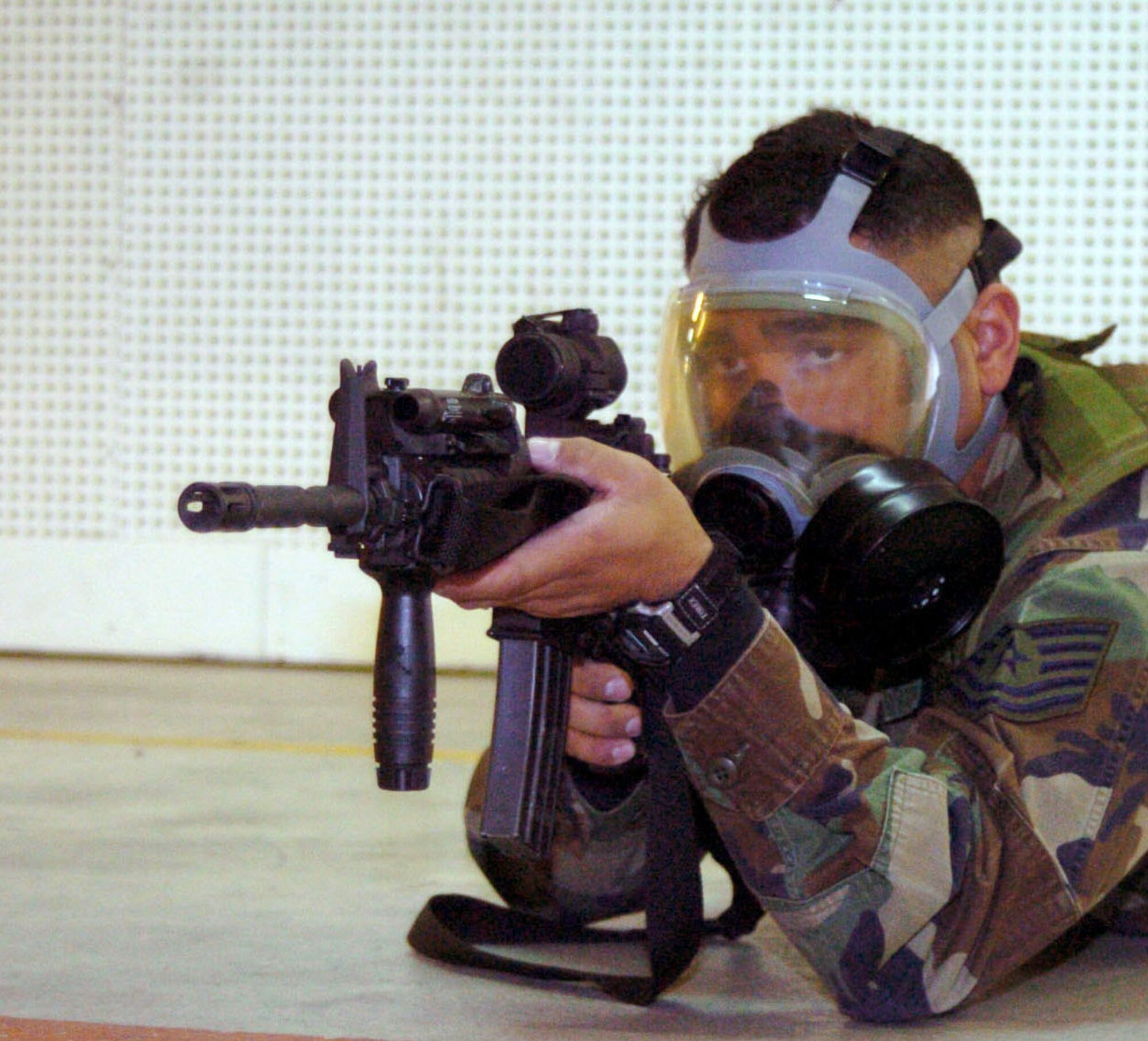 SPANGDAHLEM AIR BASE, Germany -- Tech. Sgt. Lorenzo Javier practices shooting an M-4 rifle while wearing his gas mask.  About six months ago, the Air Force began requiring all Airmen qualifying for weapons training to shoot while wearing their gas masks.  Sergeant Javier is a force protection evaluator with the 52nd Security Forces Squadron here.  (U.S. Air Force photo by Airman 1st Class Eydie Sakura)