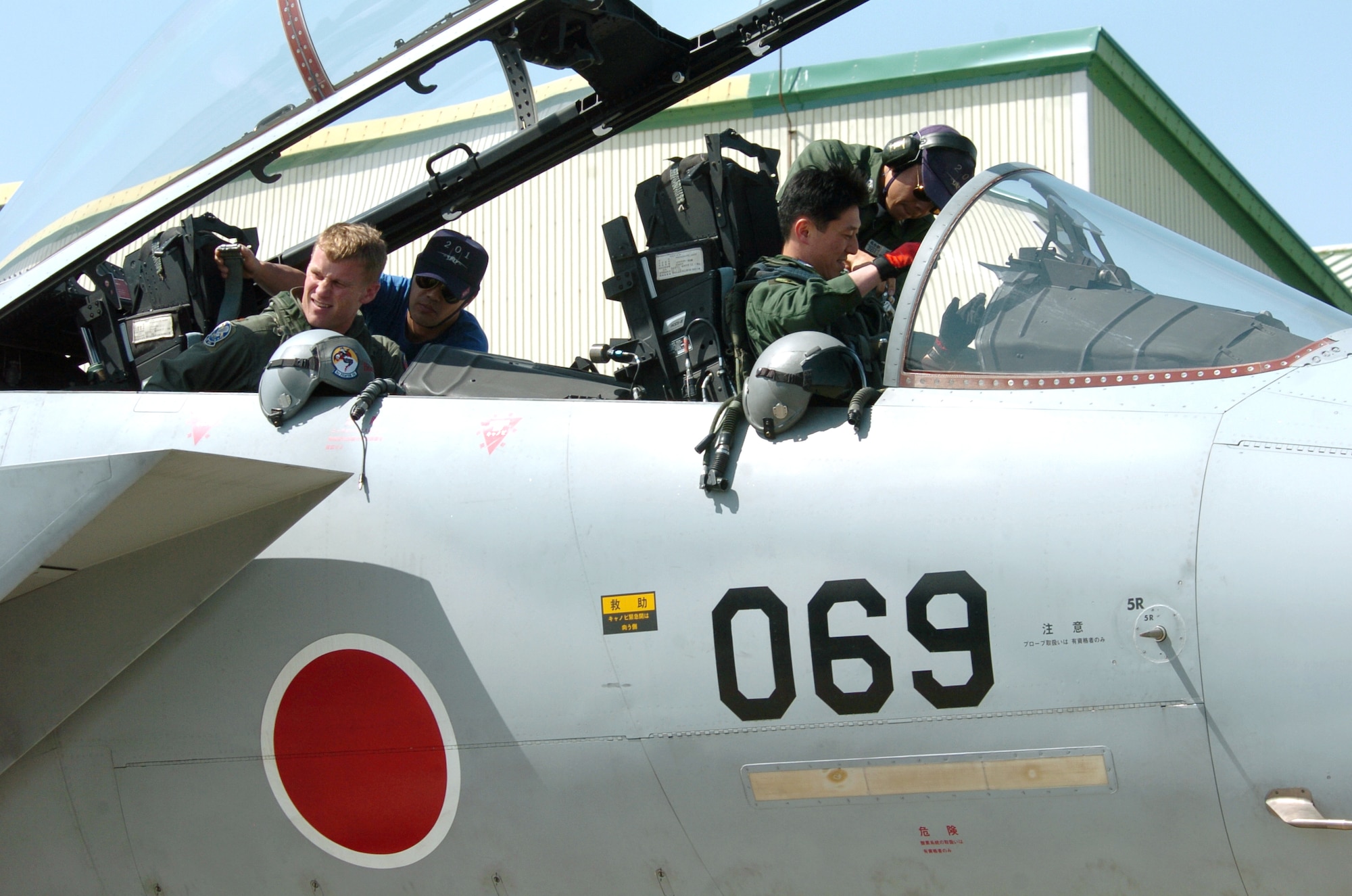 NYUTABARU AIR BASE, Japan -- Maj. Brian Bergeron (left) and Japanese Maj. Kouji Takada prepare to take off for an afternoon mission during hands-on air-to-air refueling training here.  Japanese F-15 Eagle pilots, under the watchful eye of U.S. Airmen, are getting trained to qualify in aerial refueling.  Major Bergeron is an instructor pilot with the 325th Operations Support Squadron at Tyndall Air Force Base, Fla.  (U.S. Air Force photo by Master Sgt. Val Gempis)