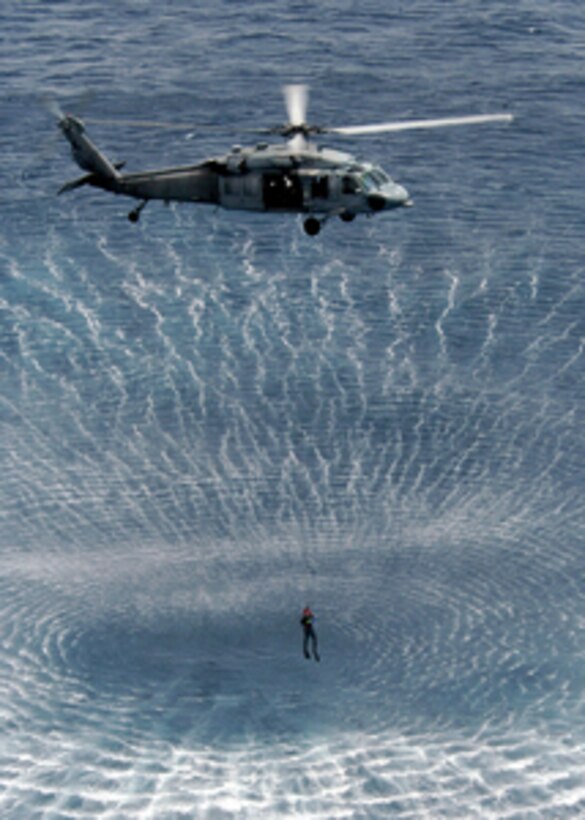 The rotor wash from a U.S. Navy MH-60S Knight Hawk helicopter makes a pattern in the Mediterranean Sea as it hoists up a search and rescue swimmer during drills on April 19, 2005. Swimmers and helo crews from the USS Kearsarge Strike Group are keeping their rescue skills sharp through training while deployed in support of the war on terror. 