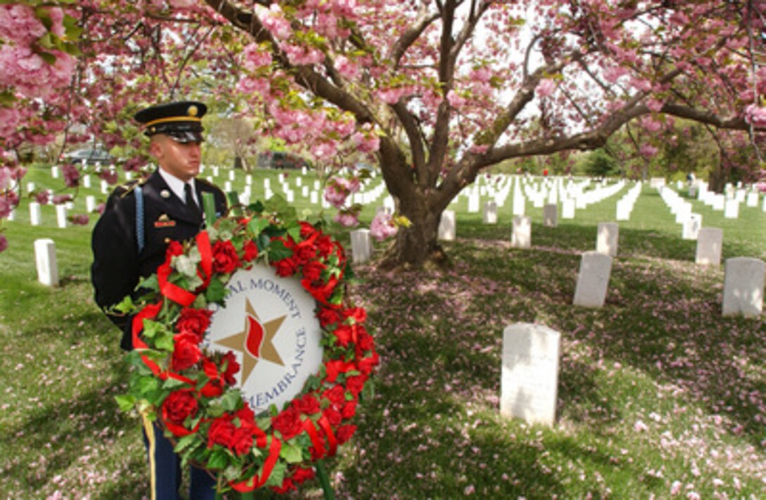 Army Pfc. John Brothers stands by to present a wreath during the 25th Annual Tribute to the Iran Hostage Rescue Mission at Arlington Cemetery, Va., on April 25, 2005. The tribute honored the eight men who died in the failed rescue mission to free 53 American hostages from Tehran, Iran on April 25, 1980. Brothers is attached to the 3rd Infantry Division, Old Guard. 