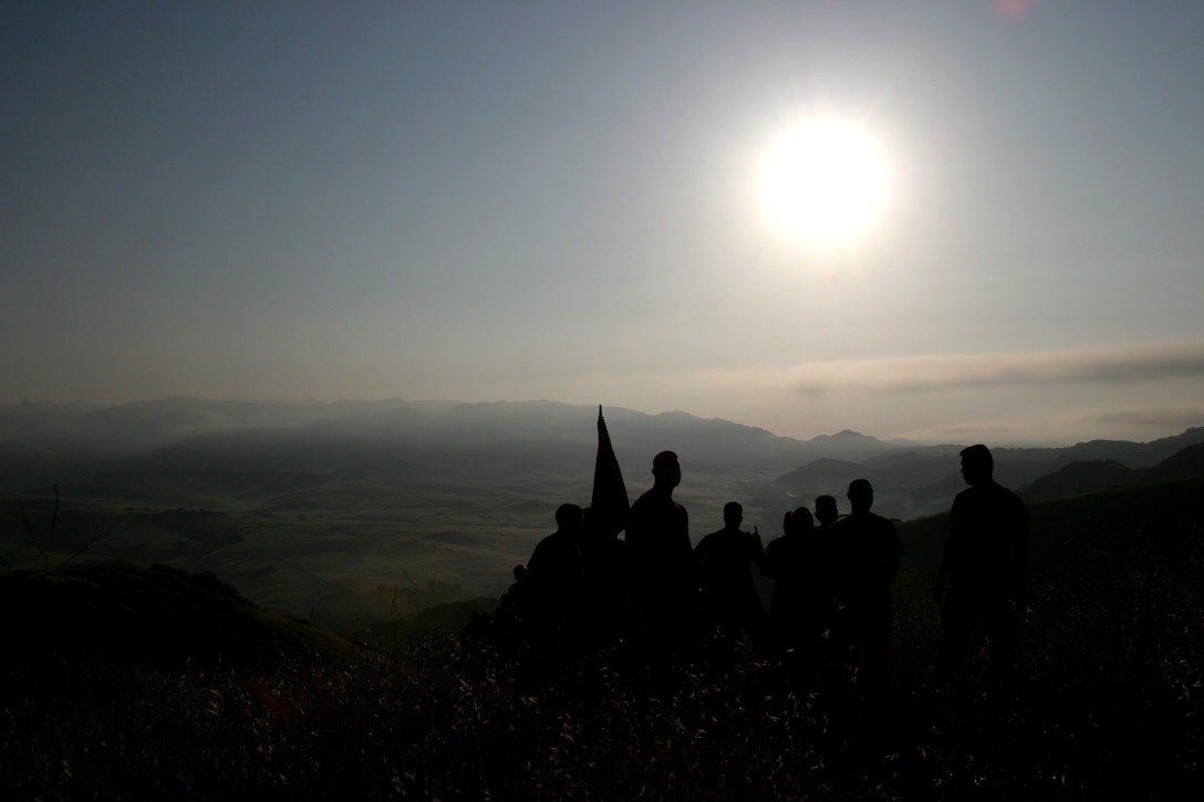 Marines from 1st Battalion, 4th Marine Regiment, hike their way to a memorial site set up just outside of Camp Horno, April 26. The site was made in memory of Marines from 1st Marine Regiment that died in support of Operation Iraqi Freedom and continues to be so for Marines from OIF II. Every Marine that hikes up the San Onofre Mountain to the memorial carries a white stone to place at the foot of the memorial. Many stones were covered with the names of the Marines that died.