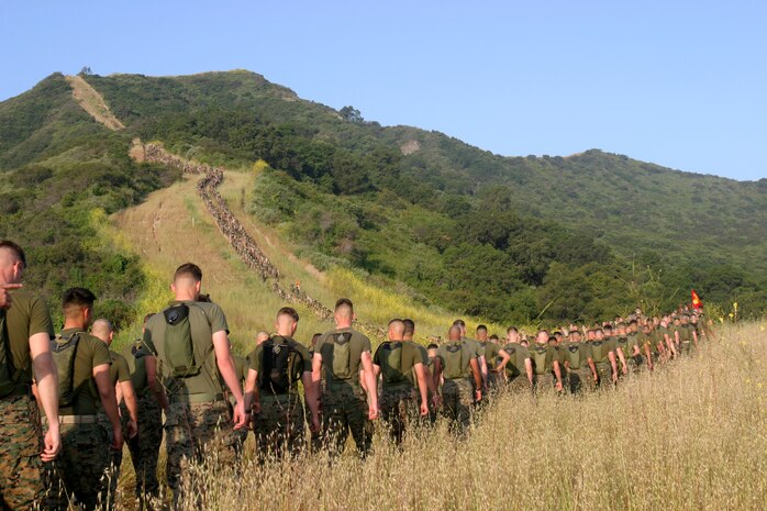 Marines from 1st Battalion, 4th Marine Regiment, hike their way to a memorial site set up just outside of Camp Horno, April 26. The site was made in memory of Marines from 1st Marine Regiment that died in support of Operation Iraqi Freedom and continues to be so for Marines from OIF II. Every Marine that hikes up the San Onofre Mountain to the memorial carries a white stone to place at the foot of the memorial. Many stones were covered with the names of the Marines that died.