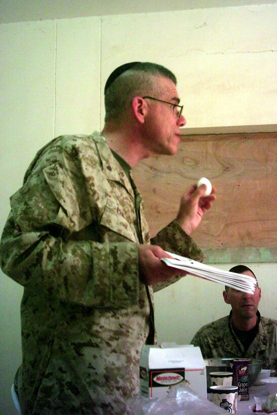 Rabbi Seth Phillips, a lieutenant commander from the Naval Submarine Base in New London, Conn., explains the symbolism of the egg as he leads the Christian Seder here 27 April.