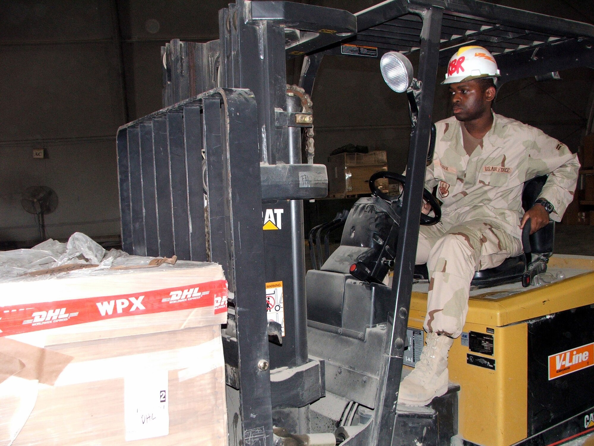 KARSHI-KHANABAD AIR BASE, Uzbekistan -- Airman 1st Class Jerome Clark moves cargo in the supply warehouse here April 26.  He is assigned to the 416th Expeditionary Mission Support Squadron's supply section and is deployed from Grand Forks Air Force Base, N.D.  (U.S. Air Force photo by Tech. Sgt. Scott T. Sturkol)