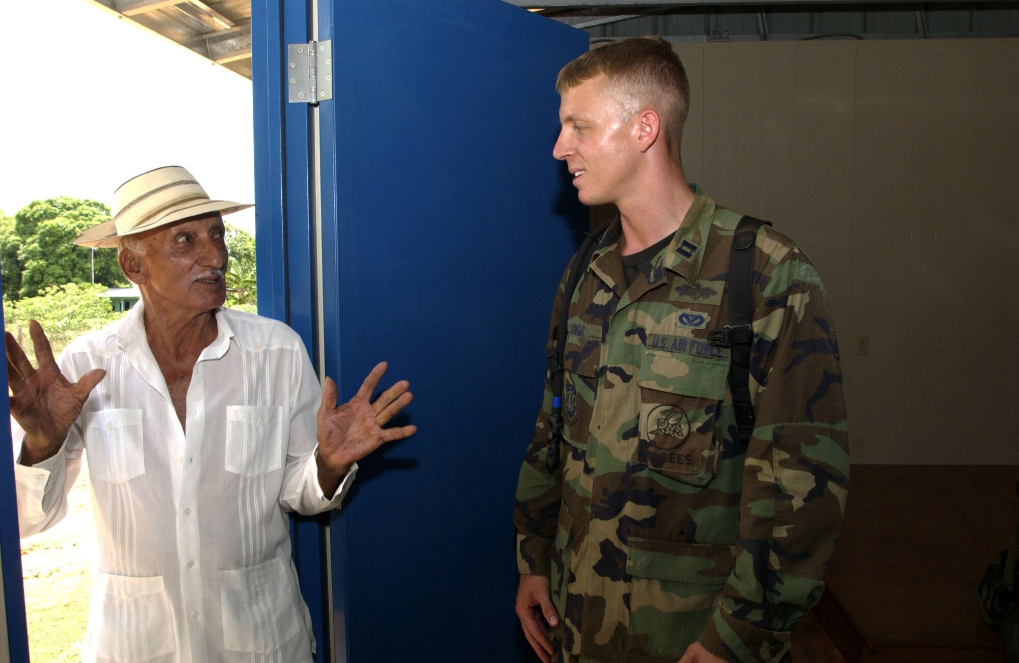 LLANO DE PIEDRA, Panama -- Capt. Star Longo talks with Bolivar Barria inside the community center the Seabees constructed here.  Captain Longo is the commander of the U.S. Naval Mobile Construction Battalion 40 (Seabees) attached to Joint Task Force Armadillo.  Task Force Armadillo is part of New Horizions 2005, a U.S. Southern Command sponsored annual training and humanitarian exercise.  Captain Longo is on a two-year exchange program with the Seabees.  (U.S. Air Force photo by Master Sgt. Lono Kollars)