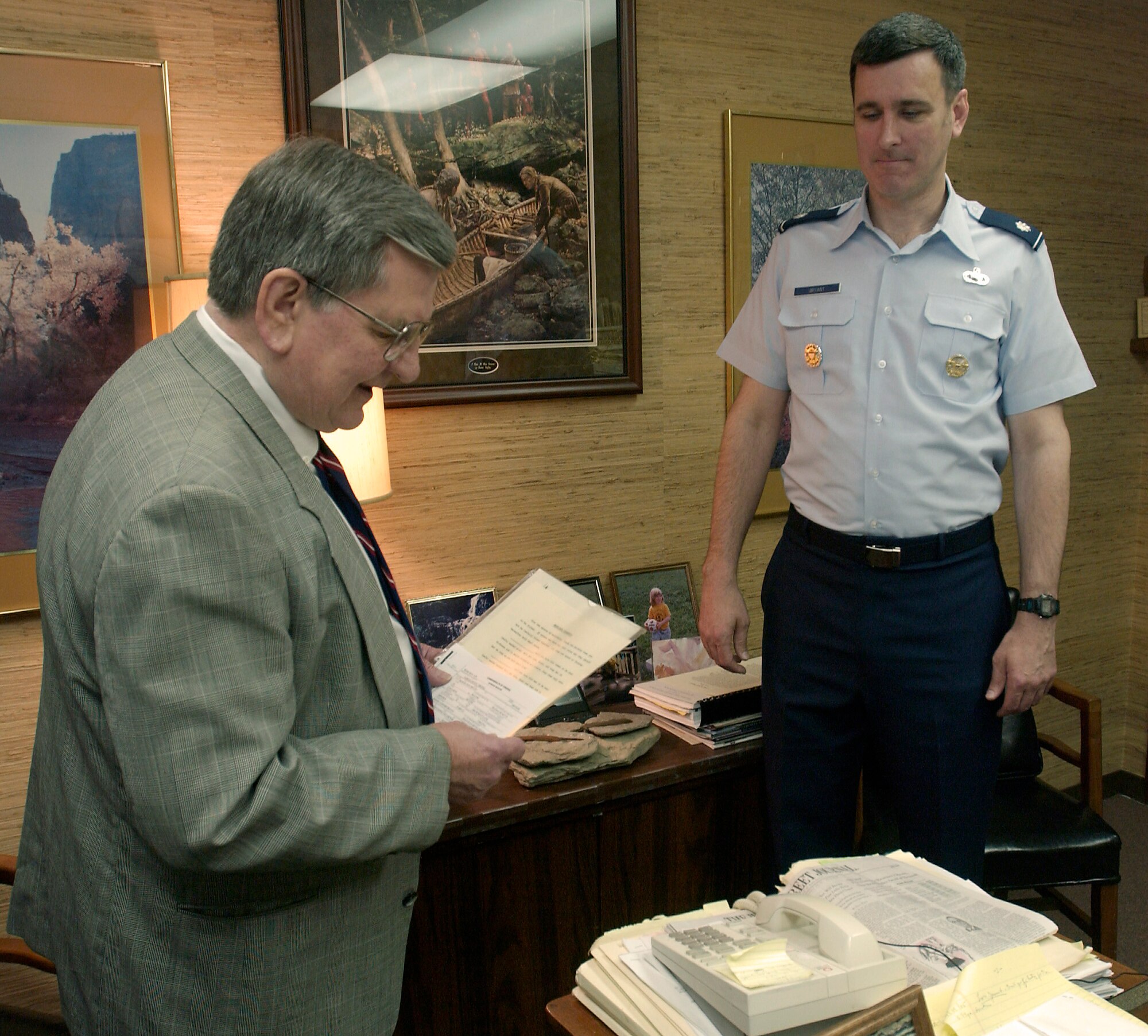 MCCLEAN, Va. -- Attorney Conrad Marshall (left) officiates the wedding of Lt. Col. Michael Bryant and Maj. Heather Villasenor on the phone April 26.  Major Villasenor is deployed to Southwest Asia as a senior intelligence duty officer.  Colonel Bryant is the Joint Staff target operations division chief in Washington.  (U.S. Air Force photo by Master Sgt. Jim Varhegyi)