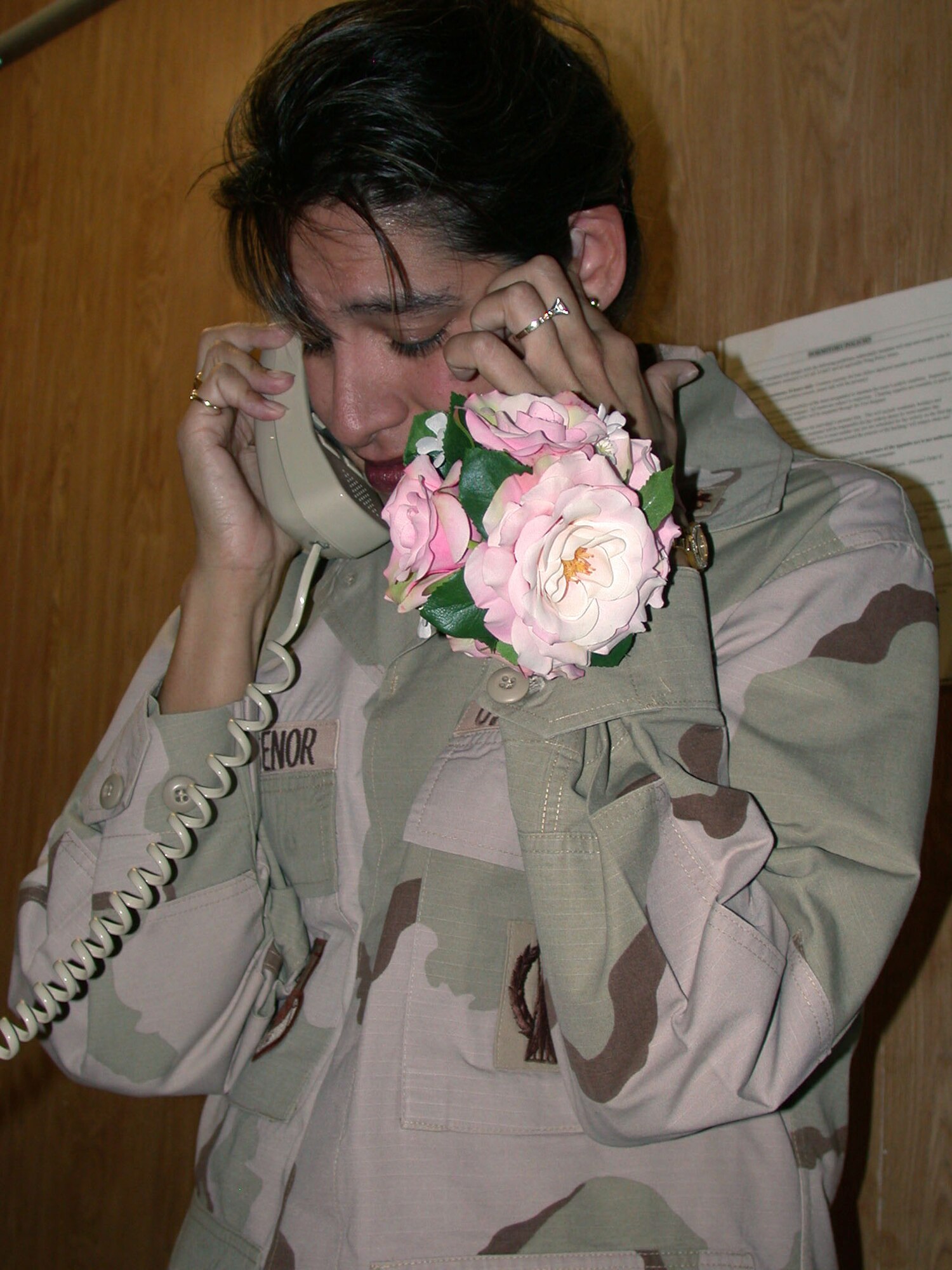 SOUTHWEST ASIA -- Maj. Heather Villasenor exchanges wedding vows with Lt. Col. Michael Bryant over the phone at a forward-deployed location April 26.  Colonel Bryant called from his lawyers office in McLean, Va.  Colonel Bryant is the Joint Staff target operations chief in Washington and Major Villasenor is a senior intelligence duty officer.  (U.S. Air Force photo by 1st Lt. John Fage)