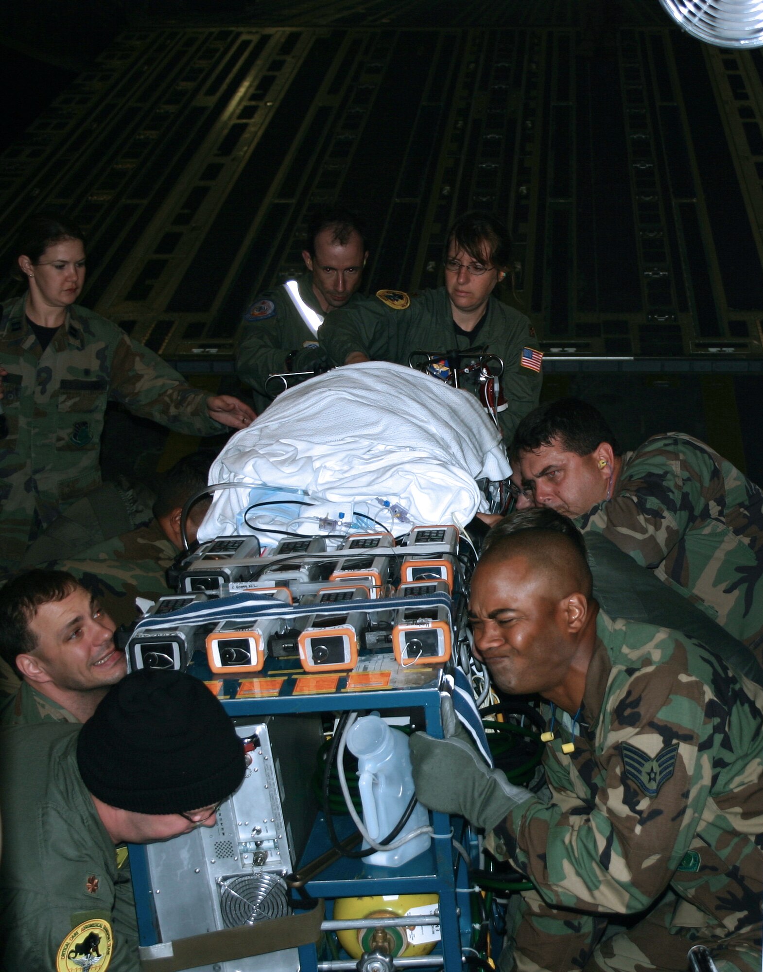 SAN ANTONIO -- A medical team from Wilford Hall Medical Center at nearby Lackland Air Force Base moves 10-month-old Carle David and a 900-pound portable heart-lung bypass machine onto an ambulance at San Antonio International Airport on April 28.  Carle is diagnosed with a severe case of pneumonia and was medically evacuated from Anchorage, Alaska.  Her chance of recovering rose from 10 percent to 90 percent.  (U.S. Air Force photo by 1st Lt. Benjamin Silva)
