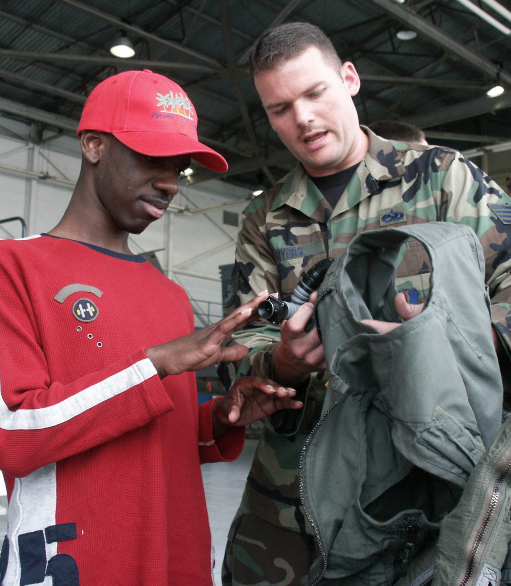 EGLIN AIR FORCE BASE, Fla. -- Staff Sgt. Tracy Myers lets Joseph Dorsey touch flight equipment during his senior class' tour of the 33rd Fighter Wing here April 26.  The class is from the Tennessee School for the Blind in Nashville.  Sergeant Myers is an instructor with the 33rd Maintenance Operations Squadron.  (U.S. Air Force photo by Staff Sgt. Robert Zoellner)