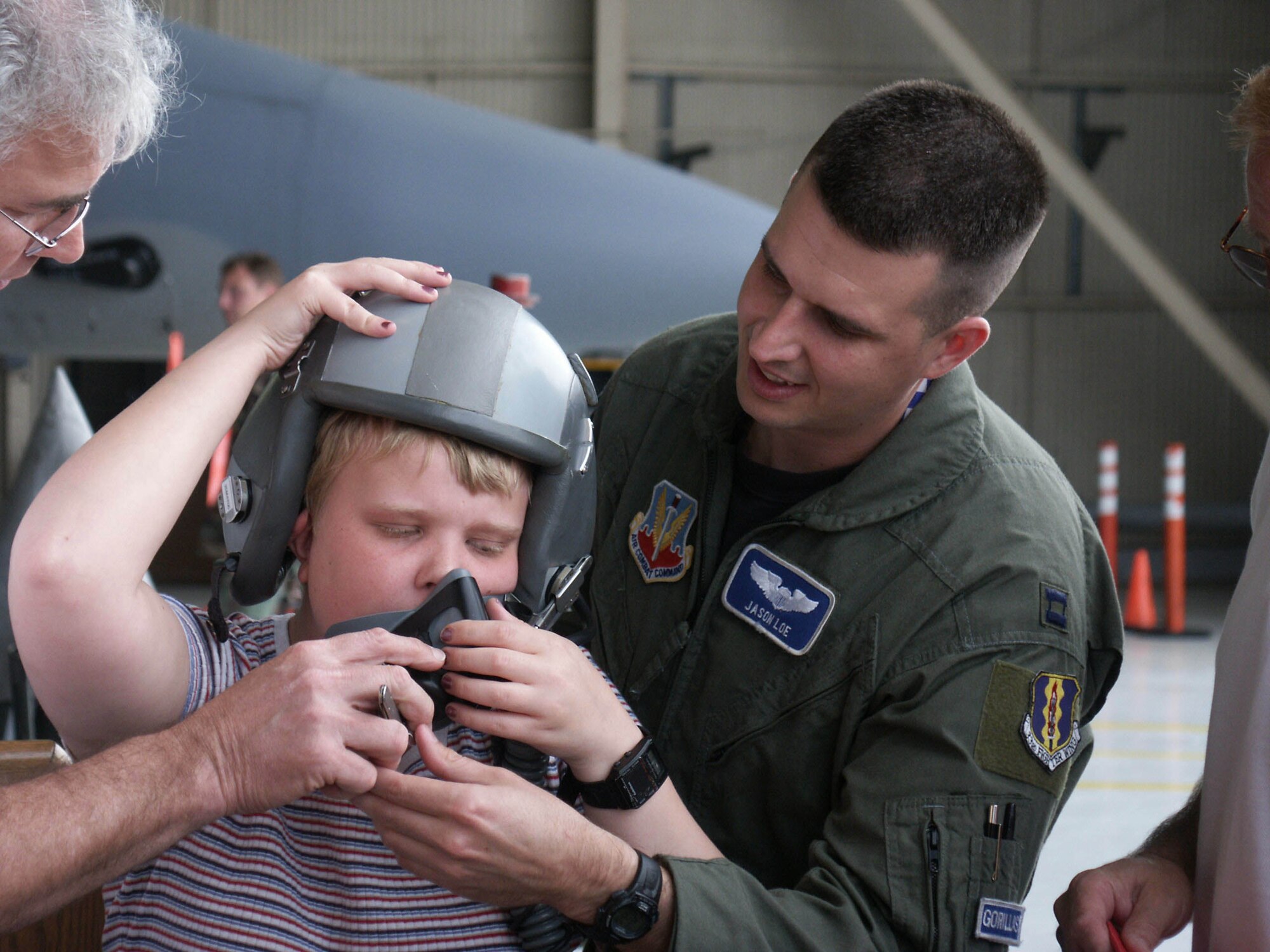 EGLIN AIR FORCE BASE, Fla. -- Capt. Jason Loe lets Summer Dales try on a helmet during her senior class' tour of the 33rd Fighter Wing here April 26.  The class is from the Tennessee School for the Blind in Nashville.  Captain Loe is a 58th fighter Squadron F-15 Eagle pilot.  (U.S. Air Force photo by Staff Sgt. Robert Zoellner)