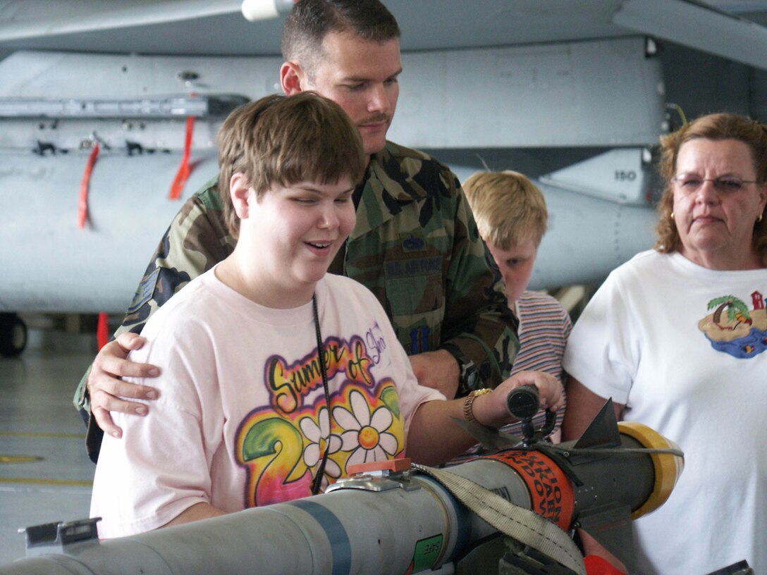 EGLIN AIR FORCE BASE, Fla. -- Staff Sgt. Tracy Myers lets Shannon Bowen touch an F-15 Eagle missile during her senior class' tour of the 33rd Fighter Wing here April 26.  The class is from the Tennessee School for the Blind in Nashville.  Sergeant Myers is an instructor with the 33rd Maintenance Operations Squadron.  (U.S. Air Force photo by Staff Sgt. Robert Zoellner)