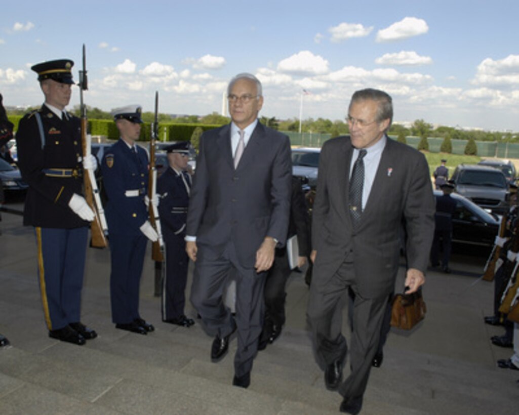 Secretary of Defense Donald H. Rumsfeld (right) escorts Greek Minister of National Defense Spilios Spiliotopoulos through an honor cordon and into the Pentagon on April 27, 2005. Rumsfeld and Spiliotopoulos will meet to discuss defense issues of mutual interest. 