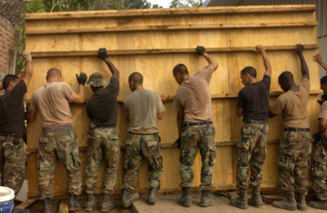 Air Force engineers with the 99th Civil Engineering Squadron use a lot of muscle to move a concrete form at the Santa Clara clinic-building project in San Vicente, El Salvador, on April 25, 2005. The clinic is part of the New Horizons Exercise projects that will provide two new schools and three clinics in areas of San Vicente that were hit by earthquakes. The engineers of the 99th are deployed for the exercise from Nellis Air Force Base, Nev. 