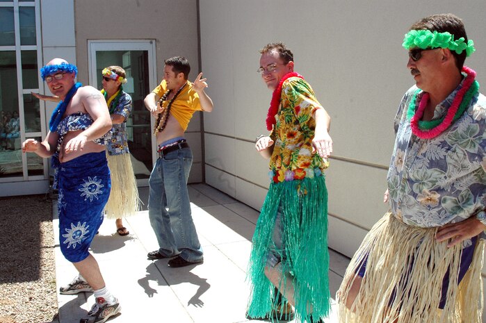 The "Men of Branch Medical Clinic Yuma" attempt their own version of a native Hawaiian dance in "traditional attire" at the clinic's Second Annual Hawaiian Luau April 28. Events like the Luau are used to build morale and camaraderie among the officer, enlisted and civilian staff. This year's Luau coincided with a successful inspector general inspection and Joint Commission on Accreditation of Health Care Organization review, which allowed the event to also serve as a celebration.