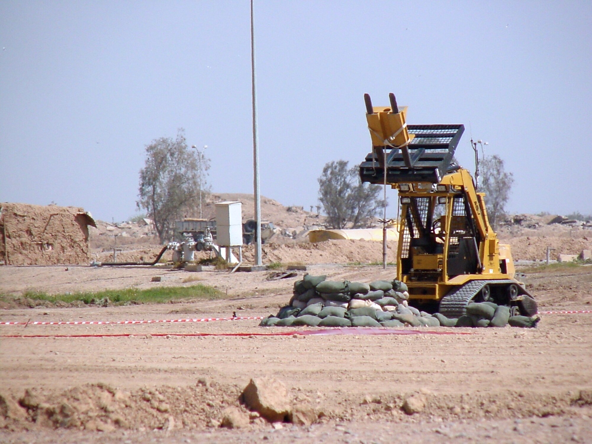 BALAD AIR BASE, Iraq -- An airborne all-purpose remote transport system clears an area of unexploded ordnance here.  Explosive Ordnance Disposal Airmen use the systems to safely and effectively clear ranges while staying out of harm's way.  (U.S. Air Force photo)