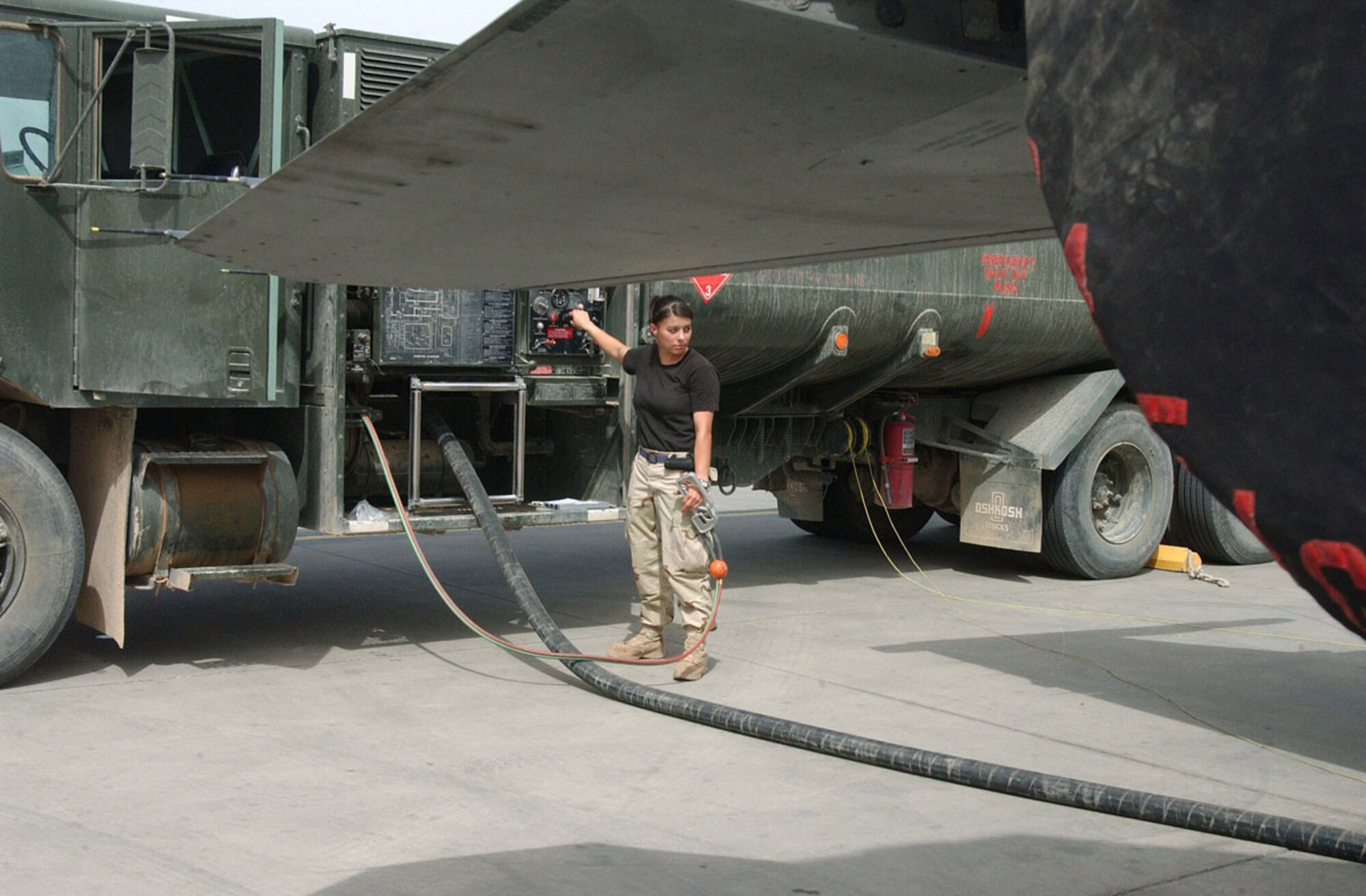 BALAD AIR BASE, Iraq -- Senior Airman Jennifer Hazelwood refuels an F-16 Fighting Falcon here.  The Airmen of the 332nd Expeditionary Logistics Readiness Squadron's fuels management flight monitor and sample fuel to ensure it is suitable for aircraft use.  Airman Hazelwood is a fuels distribution operator and is deployed from Davis-Monthan Air Force Base, Ariz.  (U.S. Air Force photo by Senior Airman Colleen Wronek)