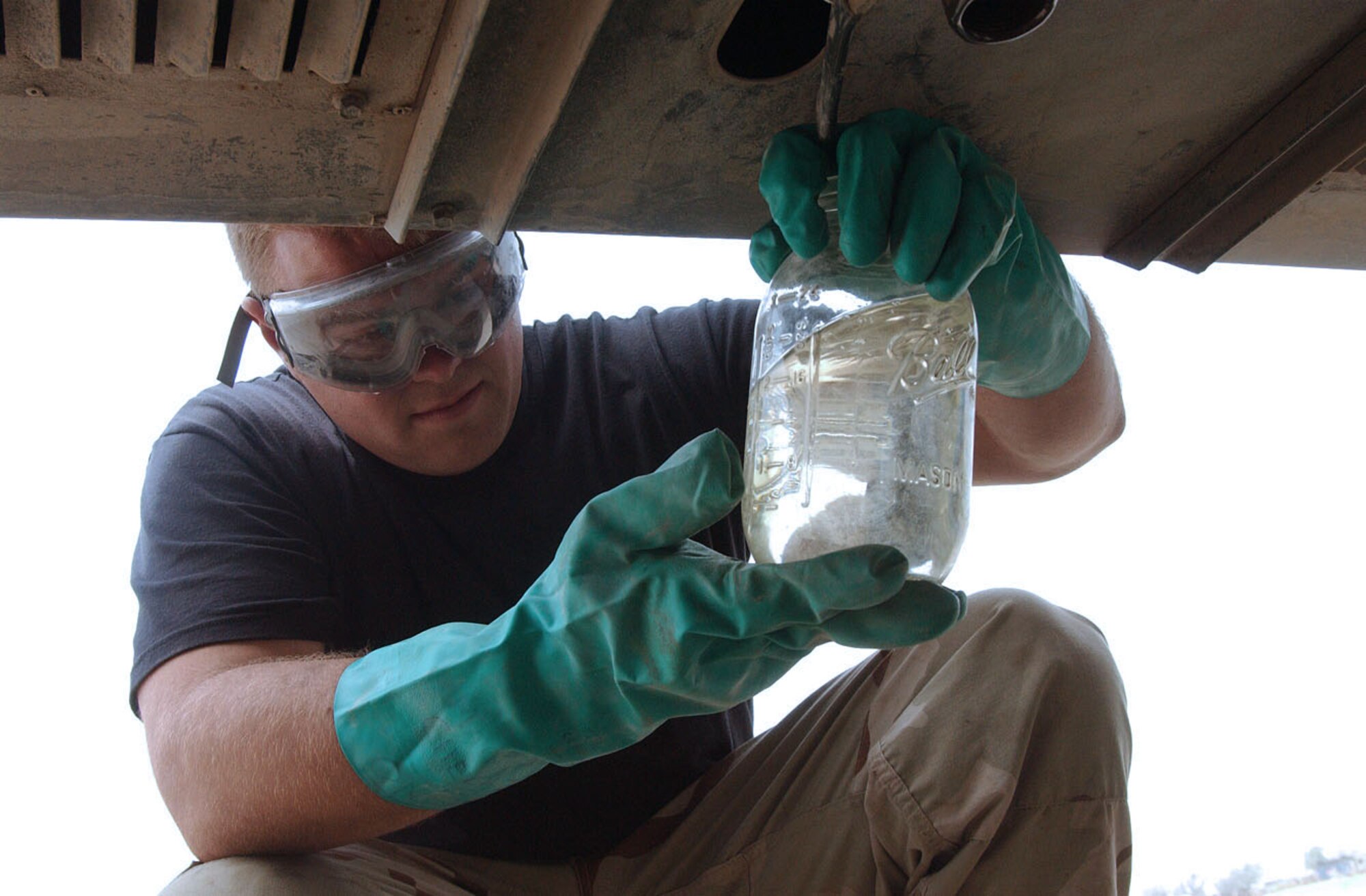 BALAD AIR BASE, Iraq -- Airman 1st Class Phillip Norton inspects a sample of fuel to see if it is clean and clear.  Airmen of the 332nd Expeditionary Logistics Readiness Squadron's fuels management flight here monitor and sample fuel to ensure it is suitable for aircraft use.  Airman Norton is a fuels distribution operator and is deployed from Davis-Monthan Air Force Base, Ariz.  (U.S. Air Force photo by Senior Airman Colleen Wronek)
