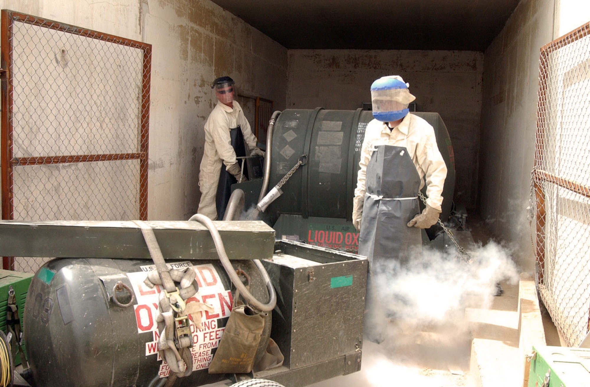 BALAD AIR BASE, Iraq -- Airman 1st Class Ben Merino monitors measures while issuing liquid oxygen as Tech. Sgt. Johnny Reagan makes sure everything is safe.  While issuing liquid oxygen, a second person must stand by as a safety monitor in case something happens.  The Airmen are assigned to the 332nd Expeditionary Logistics Readiness Squadron's fuels management flight here.  They are deployed from Davis-Monthan Air Force Base, Ariz.  (U.S. Air Force photo by Senior Airman Colleen Wronek)