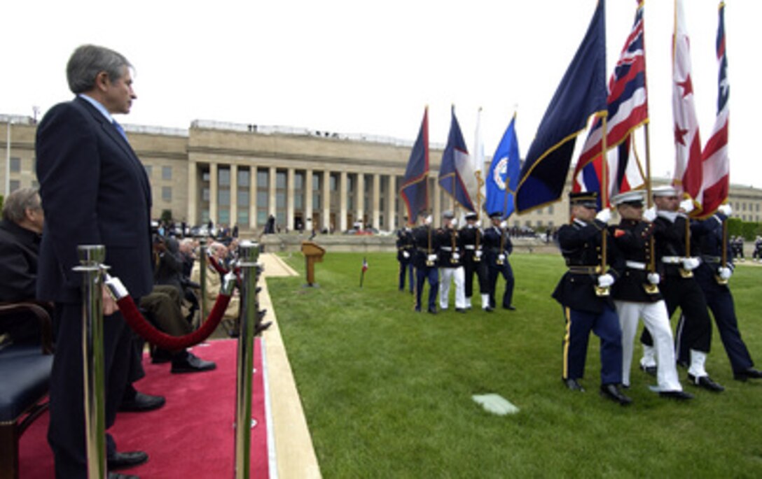 Deputy Secretary of Defense Paul Wolfowitz watches as members of the 50 State Flag Team pass in review during his farewell ceremony on the Pentagon River Parade Field on April 29, 2005. Secretary of Defense Donald H. Rumsfeld presented Wolfowitz with the Department of Defense Medal for Distinguished Public Service. Wolfowitz is leaving the Defense Department to become president of the World Bank. 