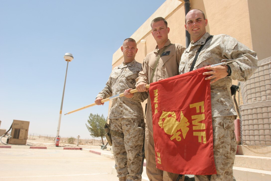AL ASAD, Iraq - Lieutenant Col. Jay Johnson, the Marine Wing Support Squadron 271 commanding officer, Lance Cpls. Lincoln Echard, a bulk fuel specialist and Christopher McCutcheon, an Aircraft Rescue and Fire Fighting crash crewman both with MWSS-271 pose with their squadron guidon here August 1. The three Marines were raised in Washington County, Ohio.