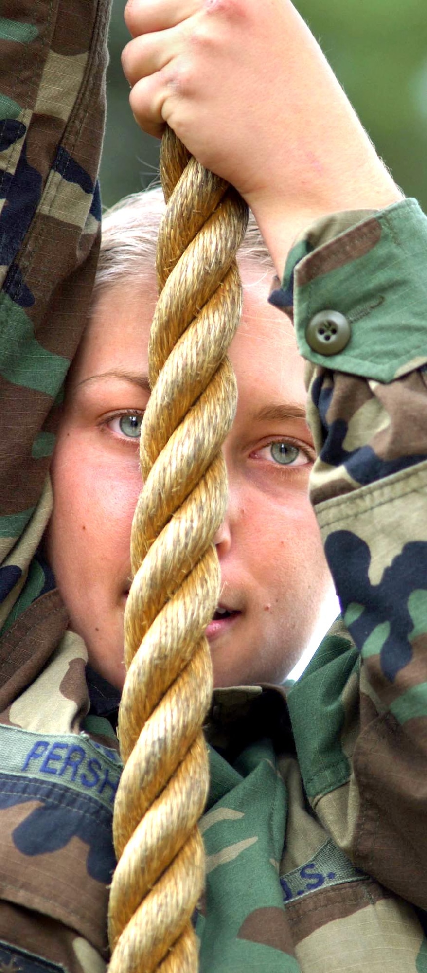 U.S. AIR FORCE ACADEMY, Colo. -- Basic Cadet Beth Pershing pulls herself up the rope on the confidence course in Jacks Valley. (U.S. Air Force photo by Charley Starr) 