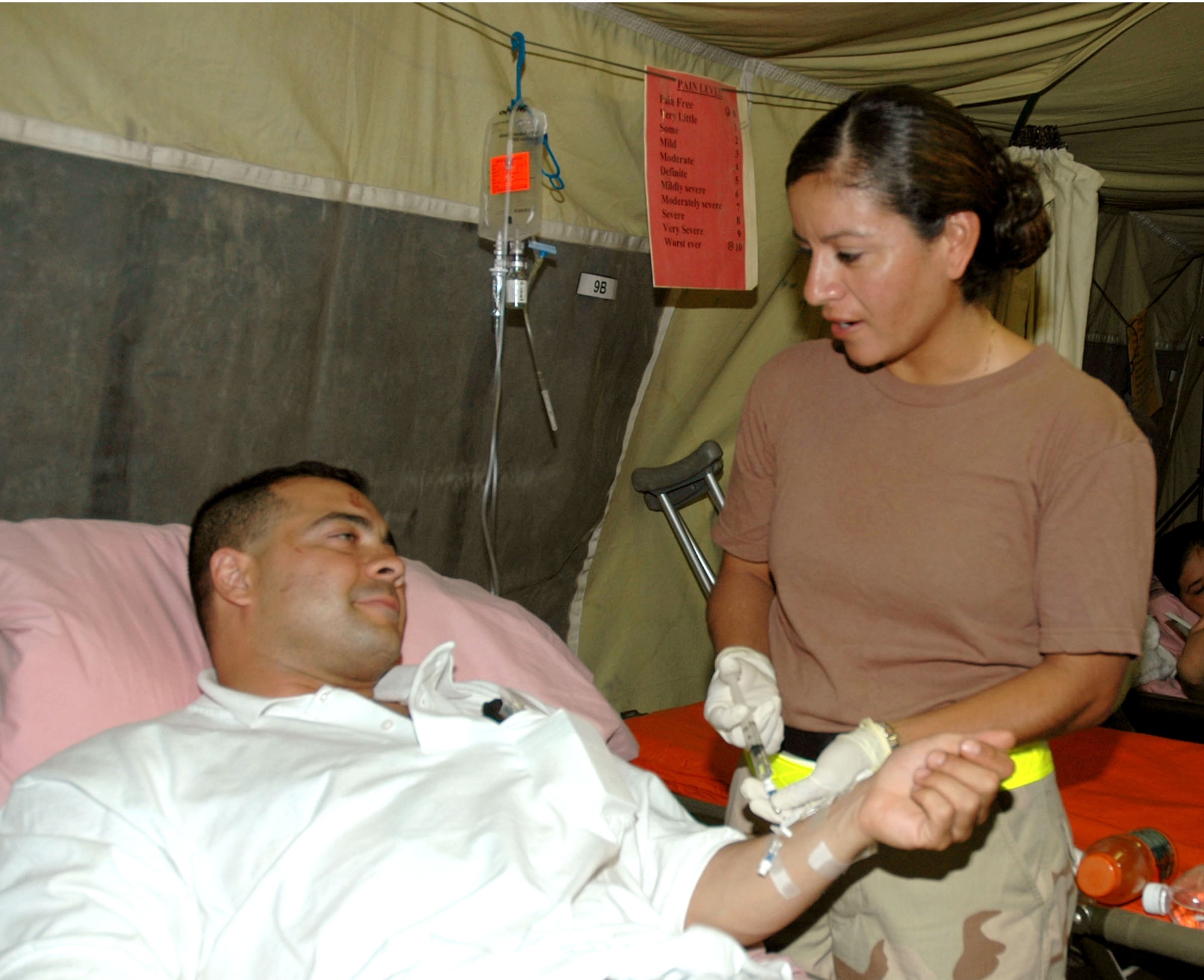 BALAD AIR BASE, Iraq -- Second Lt. Maria Sanchez cares for a patient at the 332nd Expeditionary Medical Group's contingency aeromedical staging facility.  She and the other doctors, nurses and technicians with the facility strive to ensure their patients are as comfortable as possible before being transported to Germany.  Lieutenant Sanchez is deployed from the 81st Medical Surgical Squadron at Keesler Air Force Base, Miss.  (U.S. Air Force photo by Senior Airman Chawntain Sloan)