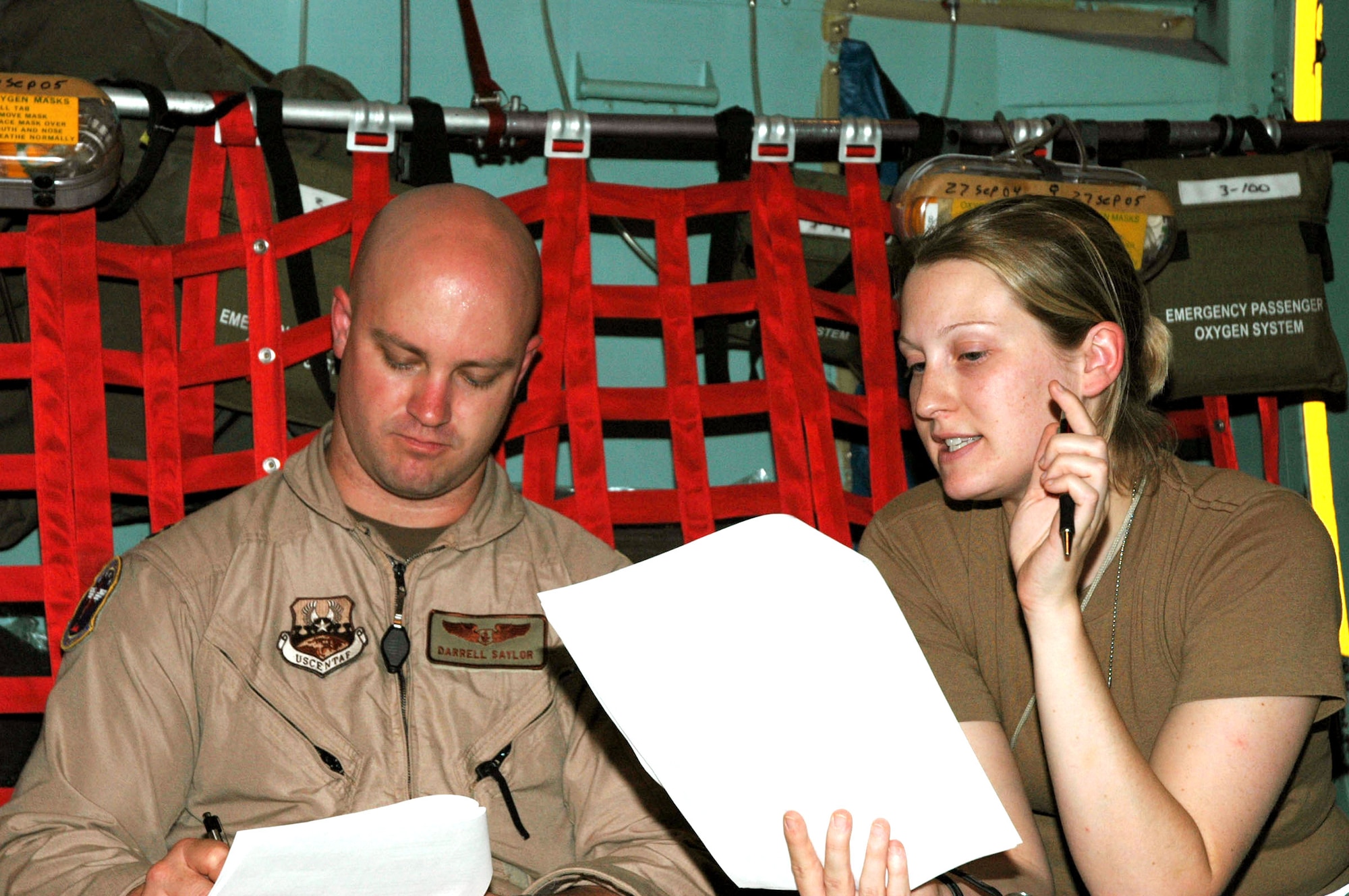 BALAD AIR BASE, Iraq -- Second Lt. Shandry Goshert briefs Capt. Darrell Saylor on the patients who will be medevaced to Germany.  She relays all pertinent medical information regarding the patients' conditions including treatment received, medication administered and special needs.  Lieutenant Goshert is a nurse with the 332nd Expeditionary Medical Group's contingency aeromedical staging facility and is deployed from Keesler Air Force Base, Miss.  (U.S. Air Force photo by Senior Airman Chawntain Sloan)