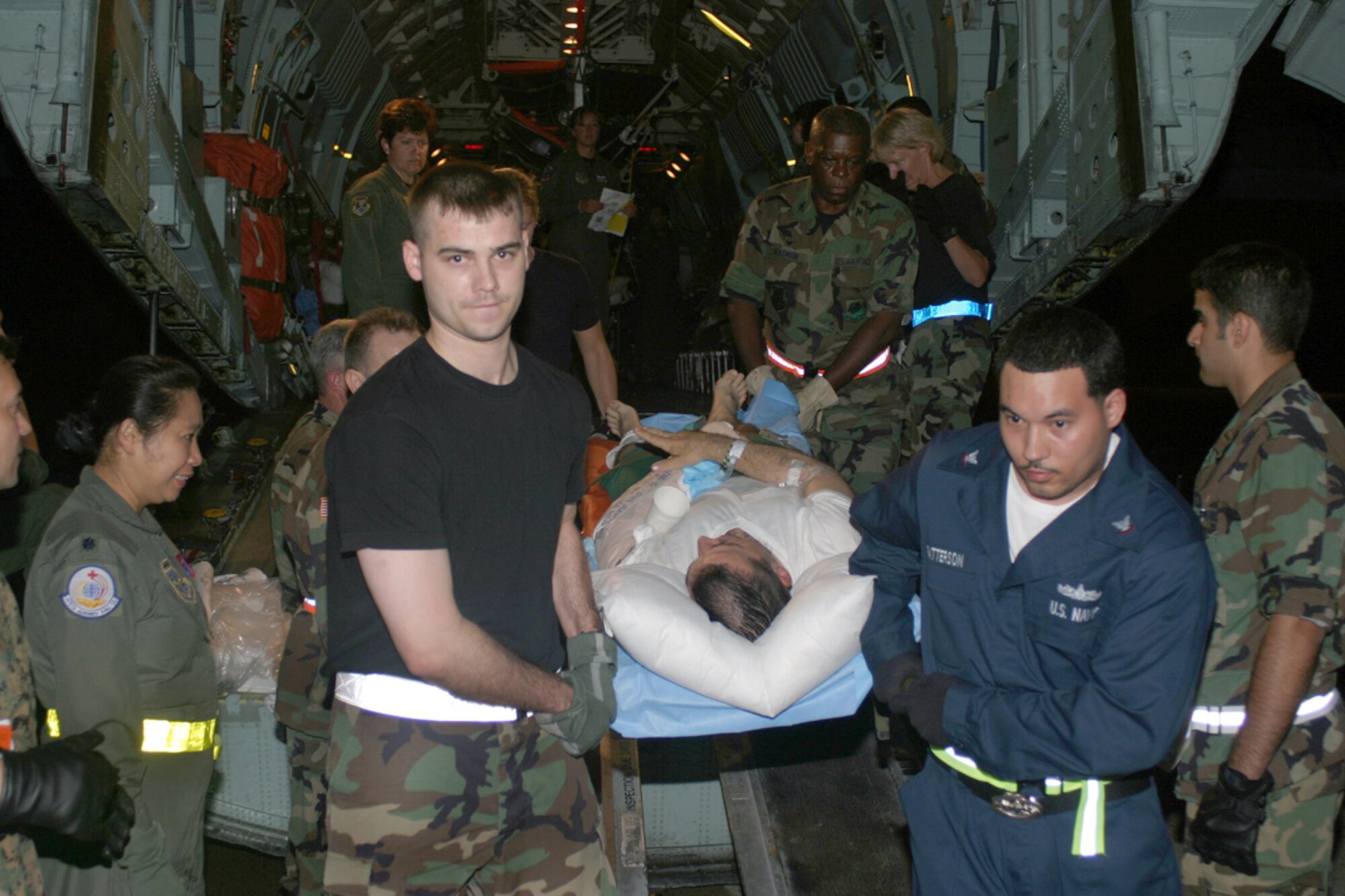 ANDREWS AIR FORCE BASE, Md. -- Senior Airman Gilbert Hildebrand (left) helps move a patient from an Air Force Reserve Command C-141 Starlifter after a flight from Ramstein Air Base, Germany.  Airman Hildebrand is from the 445th Aeromedical Evacuation Squadron at Wright-Patterson Air Force Base, Ohio.  (U.S. Air Force photo by Master Sgt. Doug Moore)