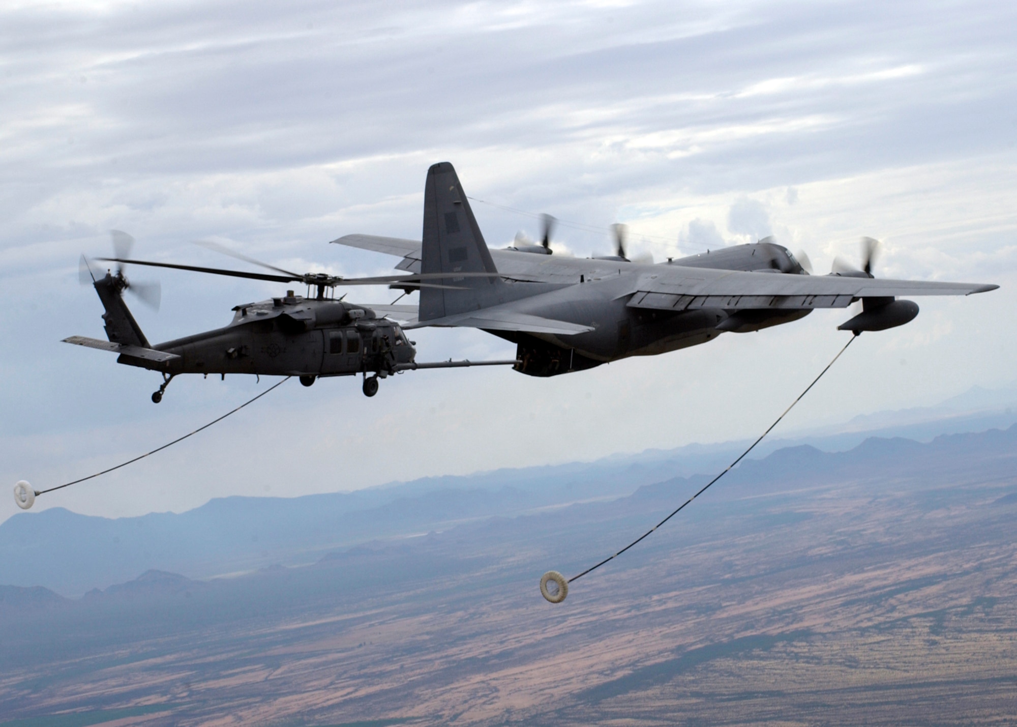 OVER ARIZONA -- An HH-60G Pave Hawk with the 55th Rescue Squadron maneuvers into position to refuel from an HC-130P/N with the 79th Rescue Squadron.  (U.S. Air Force photo by Airman 1st Class Veronica Pierce)