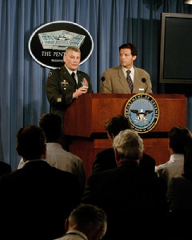 Joint Staff Deputy Director for Regional Operations Brig. Gen. Carter Ham, U.S. Army, (left) responds to a reporter's question during a Pentagon press briefing on Aug. 3, 2005. Ham and Principal Deputy Assistant Secretary of Defense for Public Affairs Lawrence Di Rita conducted the briefing. 