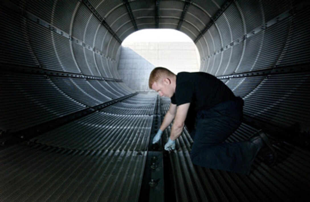 Senior Airman Jake Rutherford inspects the rear augment section of the 86th Maintenance Squadron's hush house before the test of a C-130 Hercules engine at Ramstein Air Base, Germany, on June 22, 2005. The hush house muffles the sound of the turboprop engines as they are run up to full power in testing. 