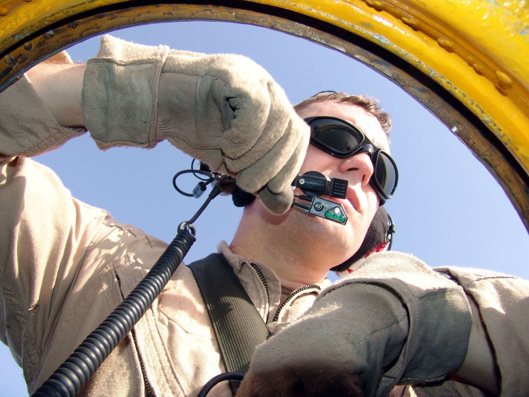 SOUTHWEST ASIA -- Capt. Jared Pavlich watches for ground traffic from the top hatch of a C-130 Hercules before an airdrop mission.  Aircrews delivered 48 bundles containing about 69,000 pounds of food rations to U.S. and Iraqi Soldiers engaged in combat operations against anti-Iraqi forces.  Captain Pavlich is a C-130 navigator with the 737th Expeditionary Airlift Squadron at a forward-deployed location and is from Pope Air Force Base, N.C.  (U.S. Air Force photo by Master Sgt. Al Gerloff)