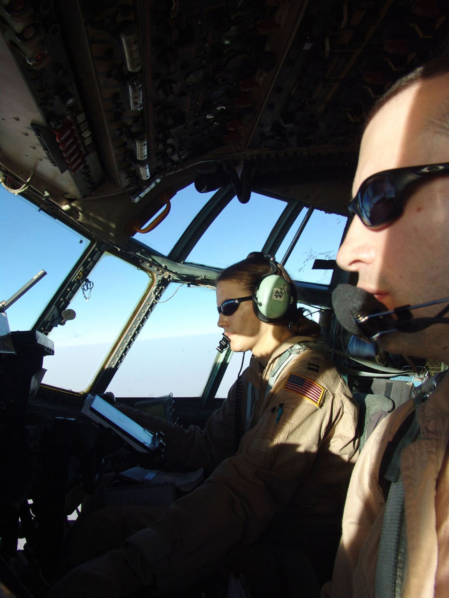 SOUTHWEST ASIA -- Capts. Jason Reed (foreground) and Anita Polsinelli prepare to launch a combat airdrop mission, delivering about 69,000 pounds of food rations for U.S. and Iraqi Soldiers engaged in combat operations against anti-Iraqi forces.  The pilots are assigned to the 737th Expeditionary Airlift Squadron at a forward-deployed location and are from Pope Air Force Base, N.C.  (U.S. Air Force photo by Capt. Carlos Diaz)