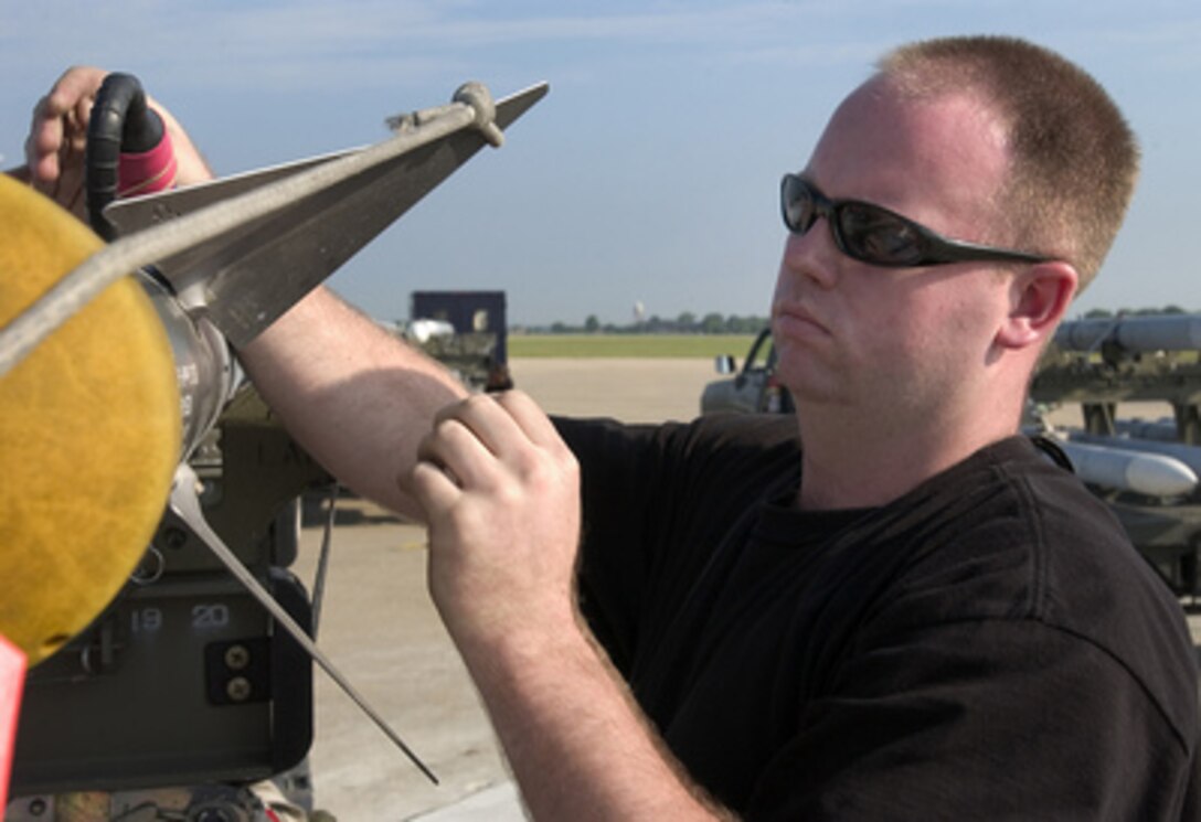 Air Force Staff Sgt. Jason Larkins inspects a AIM-9 Sidewinder missile before it is loaded onto an F-15 Eagle at Langley Air Force Base, Va., during the 1st Fighter Wing's operational readiness exercise on Aug. 2, 2005. The exercise is an evaluation of the wing's ability to prepare and deploy personnel, equipment and support assets to a combat environment. 