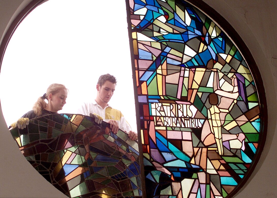 RHEIN-MAIN AIR BASE, Germany -- Workers with a local glass studio remove the Berlin Airlift Memorial Window from the base chapel Aug. 2.  The memorial honors the U.S. servicemembers who lost their lives during the Berlin Airlift in 1948 to 49.  Following restoration work, the window will find a new home in nearby Ramstein Air Base's passenger terminal as the "Gateway to Europe" transitions from Rhein-Main to Ramstein in 2006.  (U.S. Air Force photo by Airman 1st Class Eric Donner)