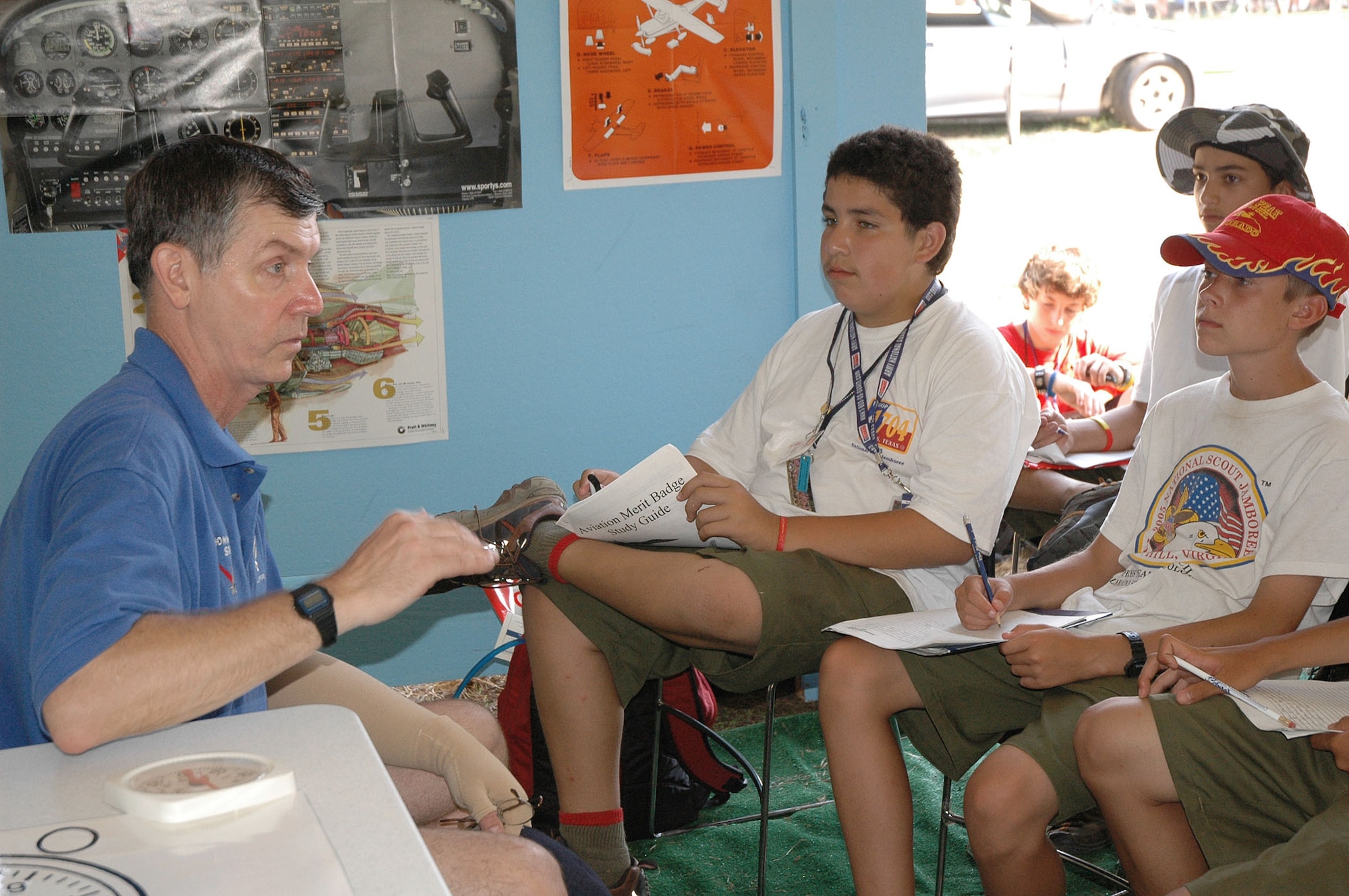 FORT A.P. HILL, Va. -- Retired Lt. Col. Tom Sawner helps Boy Scouts earn an aviation merit badge at the 2005 National Scout Jamboree by helping them understand the job of certified flight instructors.  Retired and active-duty Air Force pilots, civilian pilots, certified flight instructors and even a Navy pilot helped nearly 1,000 Boy Scouts earn their aviation merit badge during the 10-day Jamboree.  (U.S. Air Force photo by Staff Sgt. C. Todd Lopez)