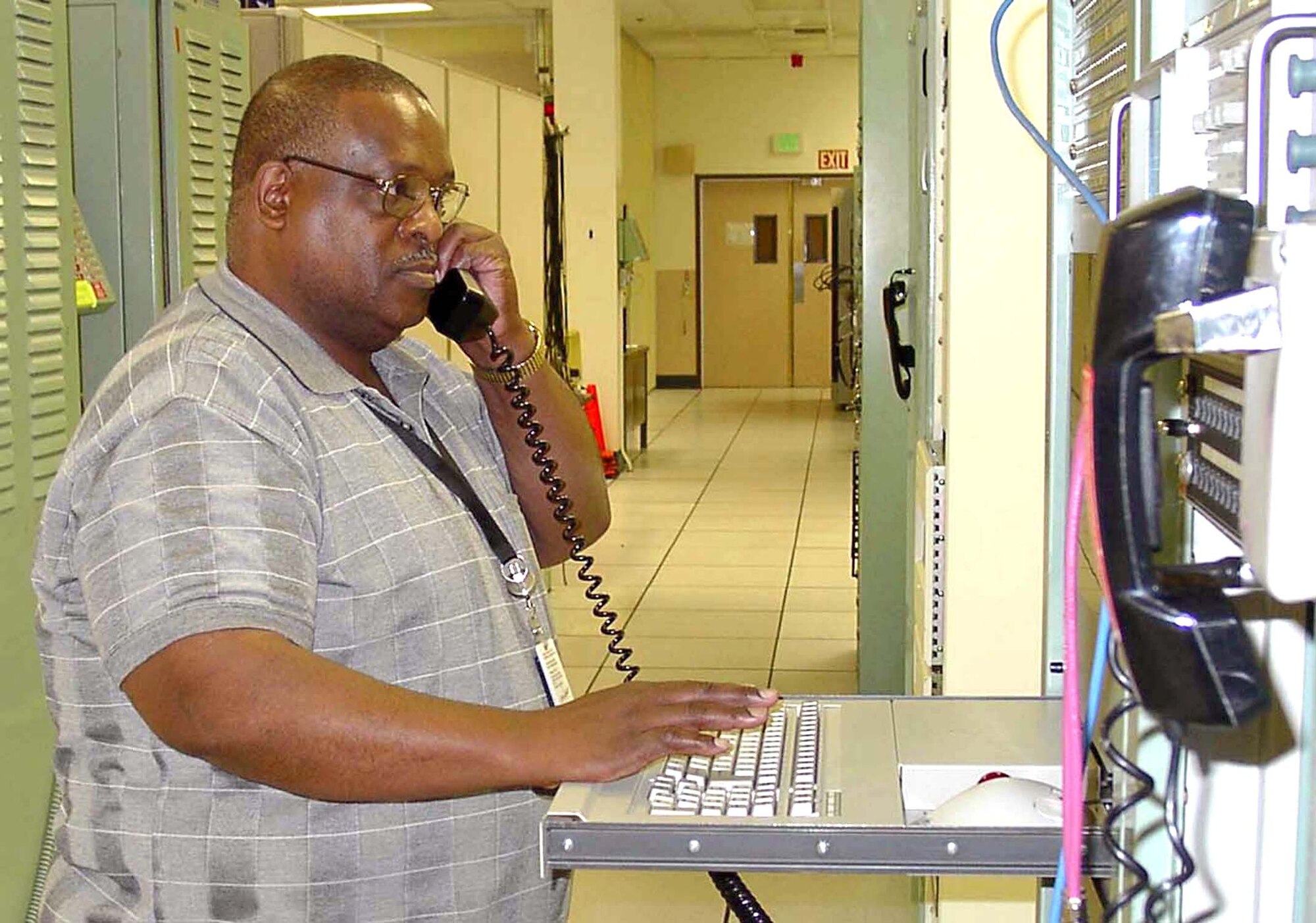 ONIZUKA AIR FORCE STATION, Calif. (AFPN) -- Cliff Gatewood configures the programmable telemetry processor to send commands and receive health and status data from a shuttle.  He has supported all 114 space shuttle missions launched by NASA.  Mr. Gatewood is the liaison for operations, equipment maintenance, integration and logistics support for NASA's communications interface to Onizuka.  (U.S. Air Force photo by Valerie Joseph)