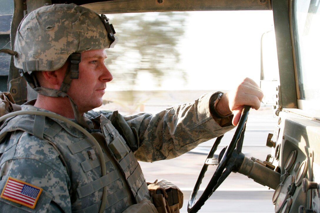 AL ASAD, Iraq ? Army Sgt. Daniel Carden, sergeant of the guard with the 1st Battalion of the 109th (Mechanized) Infantry and Carbondale, Pa., native, drives around the several observation posts his soldiers are manning to ensure they have food and water Aug. 5.  Carden and the rest of the soldiers in the unit arrived here recently to provide interior security for this former Iraqi air base and conduct convoy security missions throughout western Iraq.
