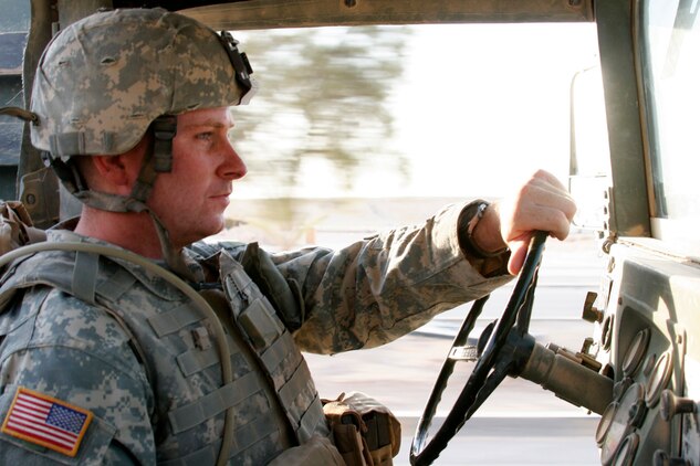 AL ASAD, Iraq ? Army Sgt. Daniel Carden, sergeant of the guard with the 1st Battalion of the 109th (Mechanized) Infantry and Carbondale, Pa., native, drives around the several observation posts his soldiers are manning to ensure they have food and water Aug. 5.  Carden and the rest of the soldiers in the unit arrived here recently to provide interior security for this former Iraqi air base and conduct convoy security missions throughout western Iraq.